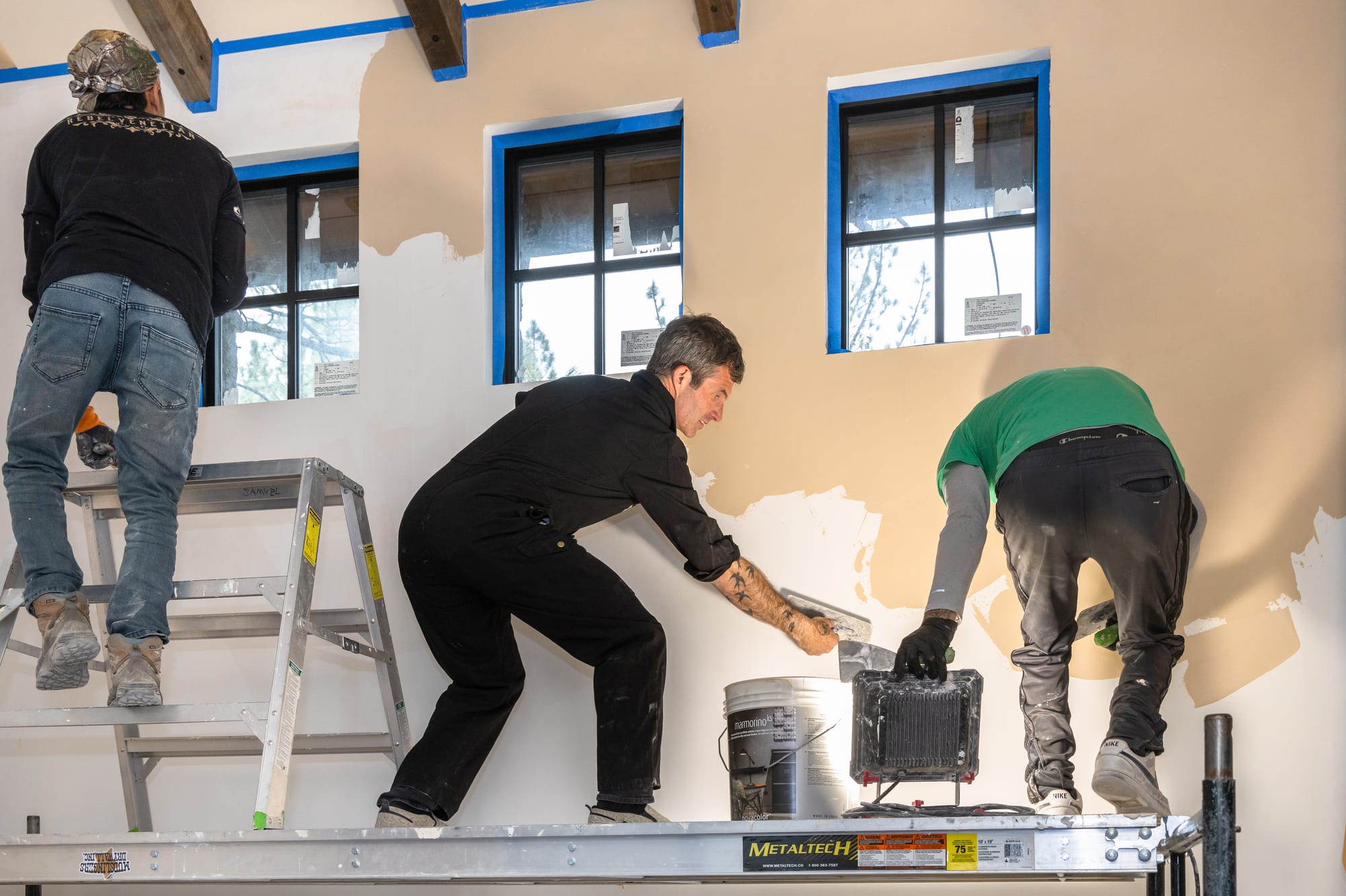 The Rebel Venetian crew applying plaster on scaffolding